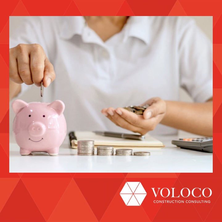 Person adding money to a piggy bank