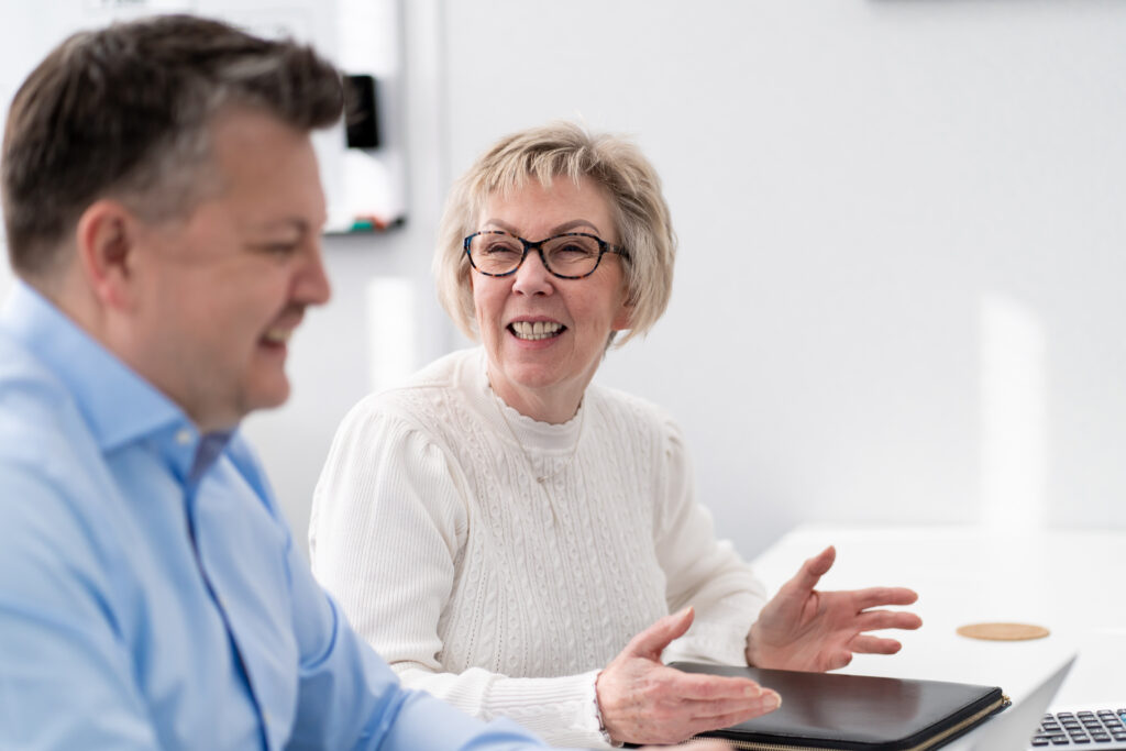 Image of staff members chatting and laughing